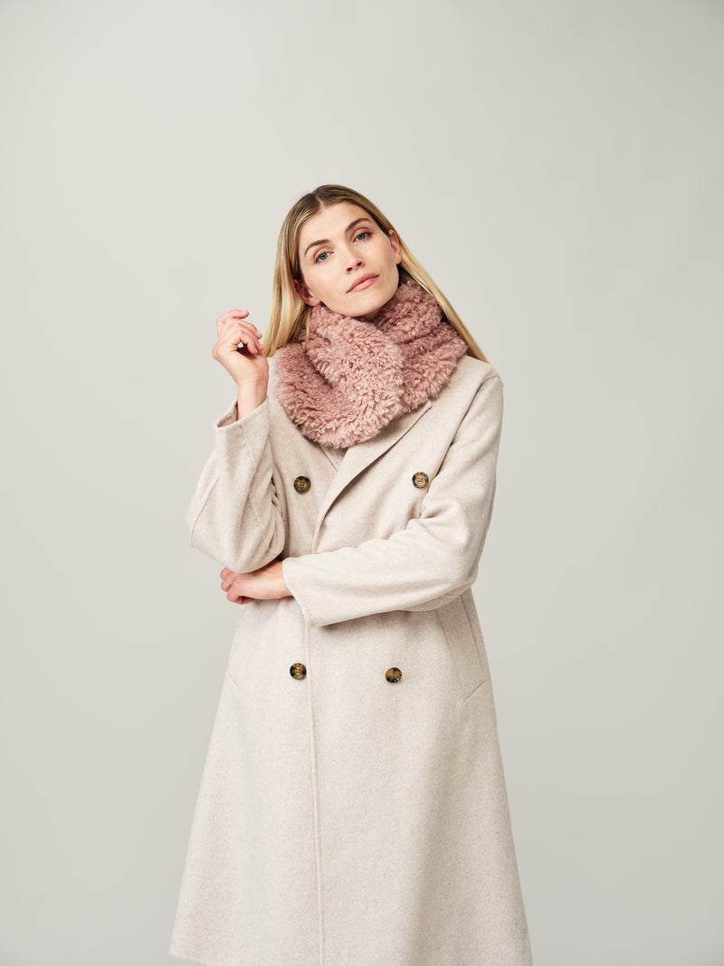 Model wearing Rose pink faux sheepskin Coco scarf by Helen Moore