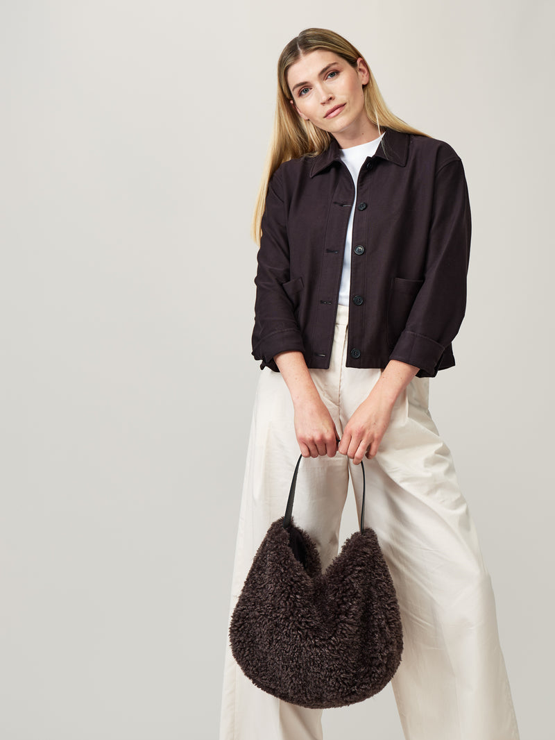 Model holding the Charcoal faux sheepskin Slouch Bag by Helen Moore