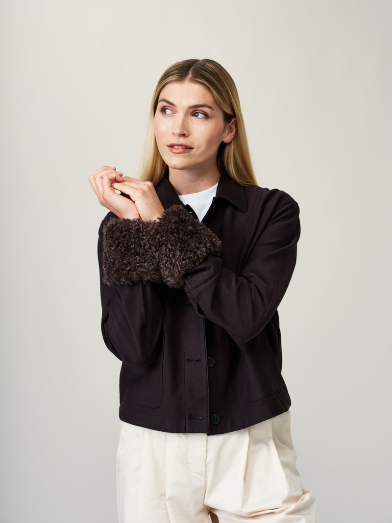 Model wearing Charcoal faux sheepskin wrist warmer cuffs by Helen Moore