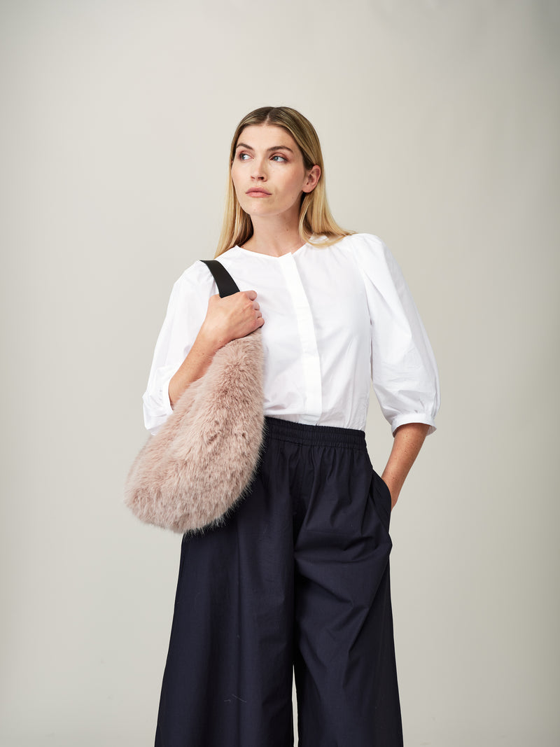 Model holding the Quartz faux fur Slouch Bag by Helen Moore