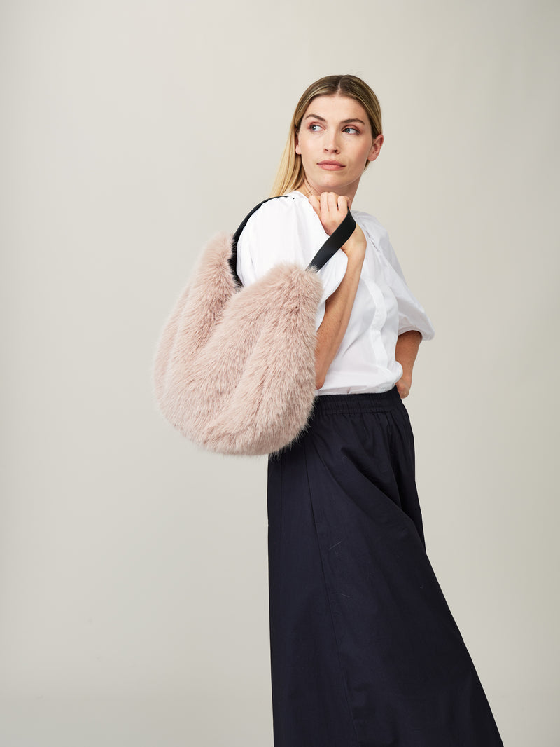 Model holding the Quartz faux fur Slouch Bag by Helen Moore