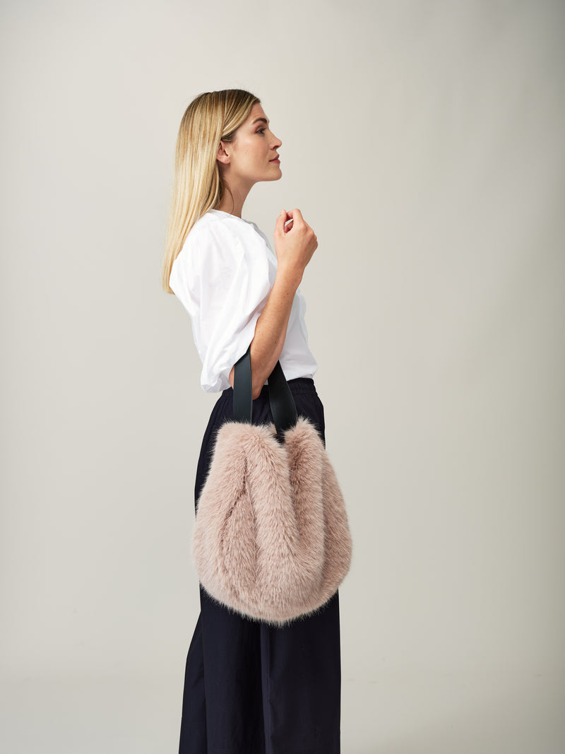 Model holding the Quartz faux fur Slouch Bag by Helen Moore