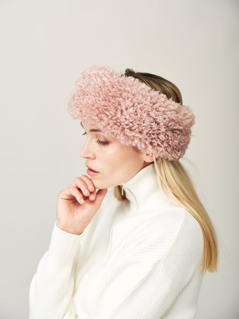 Women wearing a ski inspired outfit and a pink rose faux sheepskin headband