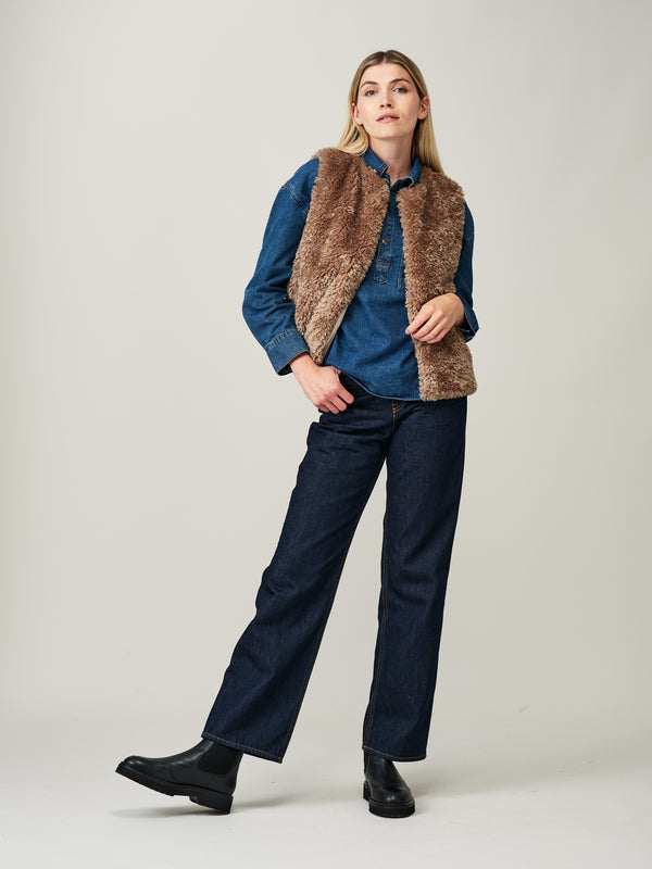 Model wearing a Taupe faux sheepskin gilet by Helen Moore