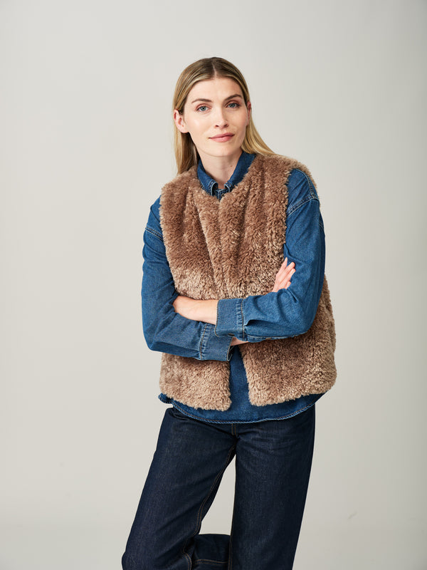 Model wearing a Taupe faux sheepskin gilet by Helen Moore