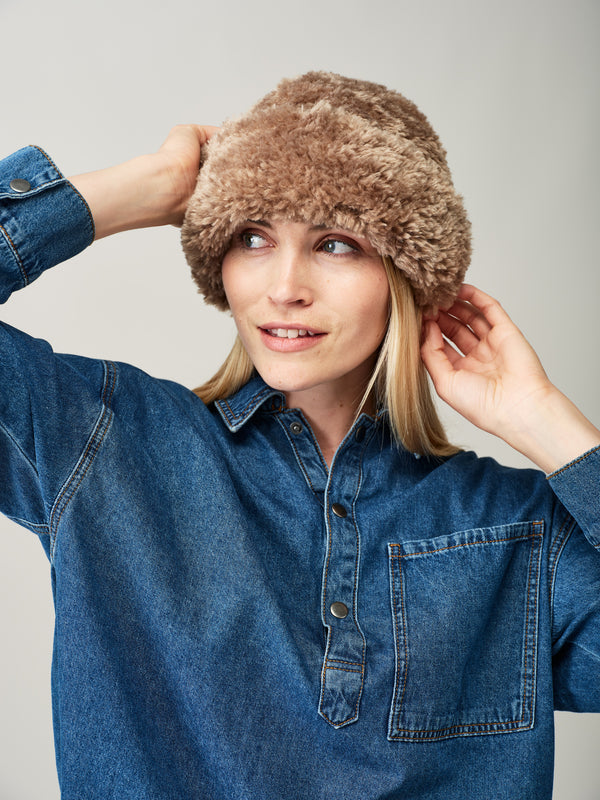 Model wearing the Taupe faux sheepskin Sherpa Hat by Helen Moore