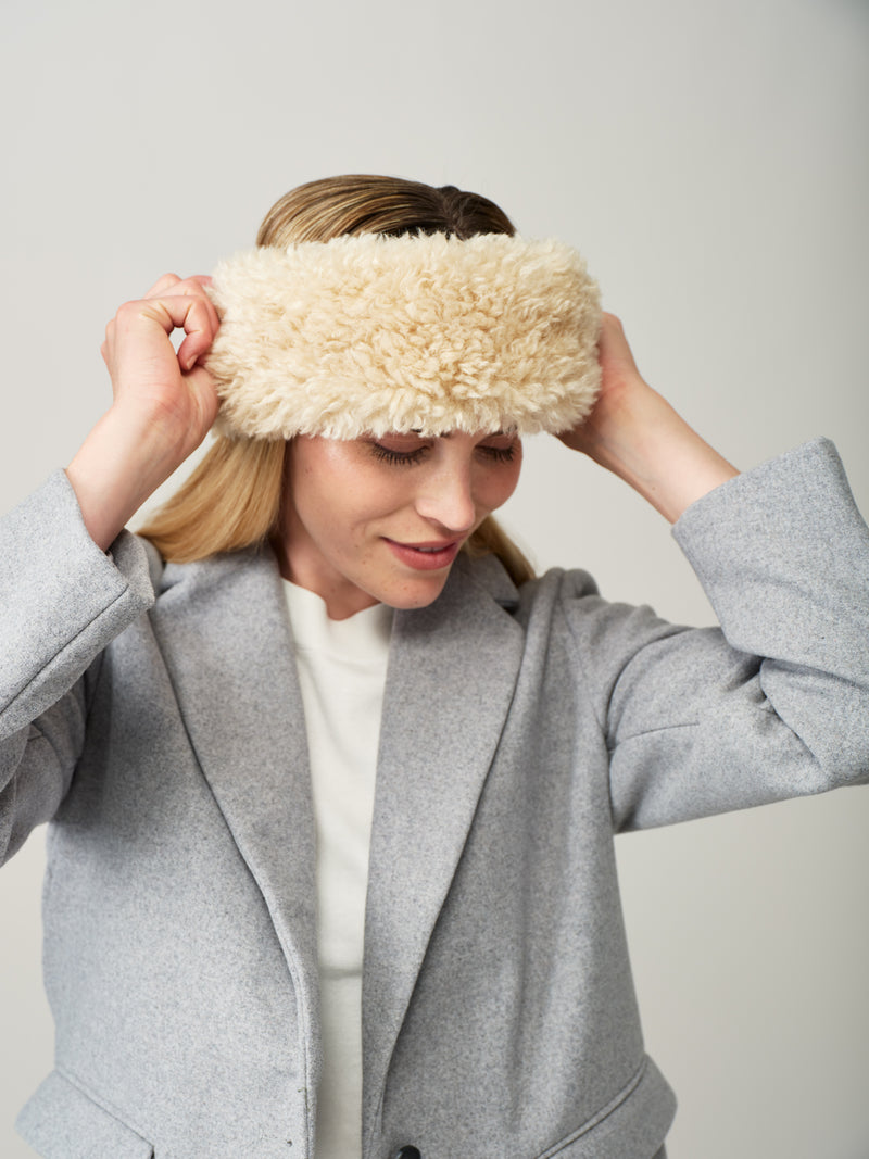 Women wearing a cream faux sheepskin headband