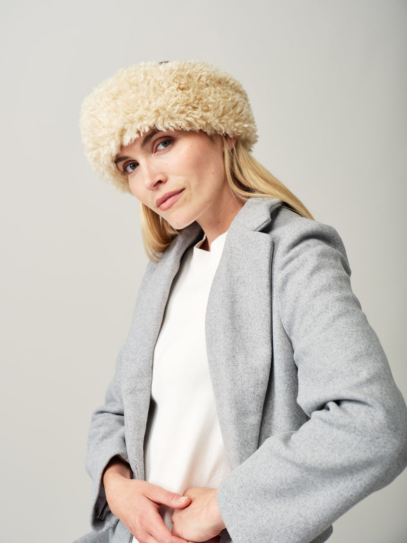 Women wearing a cream faux sheepskin headband